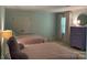 Spacious bedroom featuring two beds, a chest, and a round mirror at 6632 Summer Darby Ln, Charlotte, NC 28270