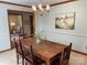 Dining room with wooden table, chandelier, and decorative painting, perfect for hosting meals at 6632 Summer Darby Ln, Charlotte, NC 28270