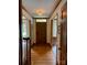 Hallway featuring hardwood flooring, trim and a stylish light fixture at 6632 Summer Darby Ln, Charlotte, NC 28270