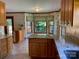 Bright kitchen featuring wood cabinets, granite counters, large window and tiled floors at 6632 Summer Darby Ln, Charlotte, NC 28270