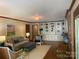 Cozy living room featuring hardwood floors, custom built-ins, and ample seating at 6632 Summer Darby Ln, Charlotte, NC 28270
