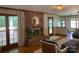 Comfortable living room with brick fireplace, hardwood floors, access to a deck and bright natural light at 6632 Summer Darby Ln, Charlotte, NC 28270