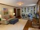 Living room with hardwood floors, built-in bookshelves, a brick fireplace, and neutral decor at 6632 Summer Darby Ln, Charlotte, NC 28270