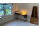Home office space with a built-in bookcase, desk, and window at 6632 Summer Darby Ln, Charlotte, NC 28270