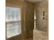 Modern shower with ceramic tile and window to let in natural light at 6632 Summer Darby Ln, Charlotte, NC 28270