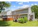 Spacious backyard featuring a deck, patio furniture, garden, white picket fence, and an exterior view of home at 6720 Long Nook Ln, Indian Trail, NC 28079