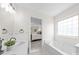 Bathroom showing a soaking tub beneath a window, and a doorway to the bedroom at 6720 Long Nook Ln, Indian Trail, NC 28079