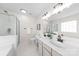 Bright bathroom featuring double sinks, white cabinets, and a glass-enclosed shower at 6720 Long Nook Ln, Indian Trail, NC 28079