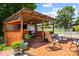 Enjoy the outdoors on this covered deck featuring a grill, seating, ceiling fan, and wooden construction at 6720 Long Nook Ln, Indian Trail, NC 28079