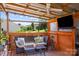 Inviting covered patio with a comfortable seating area and mounted television at 6720 Long Nook Ln, Indian Trail, NC 28079