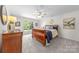 Bright main bedroom with neutral colors, carpet flooring, a ceiling fan, and natural lighting at 6720 Long Nook Ln, Indian Trail, NC 28079