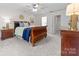 Spacious main bedroom with carpet flooring, a ceiling fan, and a walk-in closet at 6720 Long Nook Ln, Indian Trail, NC 28079