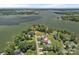Aerial view of a waterfront property with mature trees and a sprawling lake in the background at 7478 Pine Ridge Dr, Denver, NC 28037