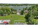 Aerial view of a luxury home with a big yard and lake view at 7478 Pine Ridge Dr, Denver, NC 28037