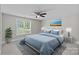Comfortable bedroom features large window, ceiling fan, calming colors, and an artistic accent wall at 7478 Pine Ridge Dr, Denver, NC 28037