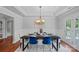 Spacious dining room with a large table, modern lighting, and a view of the outdoors at 7478 Pine Ridge Dr, Denver, NC 28037