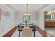 Elegant dining room with a decorative tray ceiling, wainscoting, and stylish chandelier above the table at 7478 Pine Ridge Dr, Denver, NC 28037