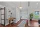Bright entryway with hardwood floors, built-in desk, and large windows showcasing natural light at 7478 Pine Ridge Dr, Denver, NC 28037