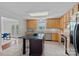 Bright kitchen featuring a center island, wood cabinets, granite countertops, and stainless steel appliances at 7478 Pine Ridge Dr, Denver, NC 28037