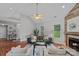 Bright living room featuring hardwood floors, a fireplace, comfortable seating, and ample natural light at 7478 Pine Ridge Dr, Denver, NC 28037