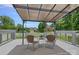 Charming patio area featuring cozy seating, overhead covering, and serene views of the landscaped backyard at 7478 Pine Ridge Dr, Denver, NC 28037
