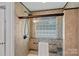 Shower stall featuring decorative tile design, glass block window, and updated fixtures at 7478 Pine Ridge Dr, Denver, NC 28037