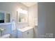 Well-lit bathroom featuring a white vanity with drawers, a mirror, and modern fixtures at 8012 Red Lantern Rd, Indian Trail, NC 28079