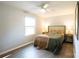 Bedroom featuring natural light, ceiling fan, hardwood floors, and neutral decor plus bedside table lamps at 8012 Red Lantern Rd, Indian Trail, NC 28079