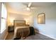 Cozy bedroom with natural light, a ceiling fan, and hardwood floors, plus neutral decor and lamps at 8012 Red Lantern Rd, Indian Trail, NC 28079