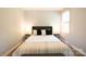 A calming bedroom featuring light grey walls, a comfortable bed, and soft, natural lighting at 8012 Red Lantern Rd, Indian Trail, NC 28079