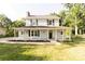 Charming two-story home with a welcoming front porch and well-maintained lawn surrounded by mature trees at 8012 Red Lantern Rd, Indian Trail, NC 28079