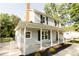 A beautiful home featuring a classic design with a covered front porch and manicured landscaping with flowerbeds at 8012 Red Lantern Rd, Indian Trail, NC 28079