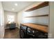 Bright laundry room with wooden countertops, shelves, washer, dryer, and a workstation at 8012 Red Lantern Rd, Indian Trail, NC 28079