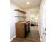Well-organized laundry room features wooden countertops, shelves, a washer, and a dryer at 8012 Red Lantern Rd, Indian Trail, NC 28079