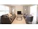 Inviting living room featuring a decorative brick fireplace, comfortable seating, and neutral tones and stylish decor at 8012 Red Lantern Rd, Indian Trail, NC 28079