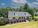 Charming two-story home featuring a large front porch, complemented by a beautifully landscaped yard and mature trees at 814 Carved Oak Ct, York, SC 29745