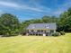 Beautiful home boasting a charming front porch and well-maintained lawn, nestled among mature trees and greenery at 814 Carved Oak Ct, York, SC 29745