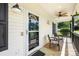 Close-up of a charming front porch featuring outdoor seating and decorative accents at 814 Carved Oak Ct, York, SC 29745