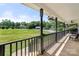 Inviting front porch with wood flooring and black railings overlooking a well-maintained lawn at 814 Carved Oak Ct, York, SC 29745