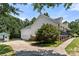 Side view of a home showcasing an attached garage and a charming covered porch at 814 Carved Oak Ct, York, SC 29745