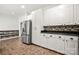 Charming kitchen with stainless steel refrigerator and white cabinets with black hardware at 814 Carved Oak Ct, York, SC 29745