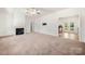 Spacious living room with a fireplace, neutral carpet, and an open doorway to the kitchen at 814 Carved Oak Ct, York, SC 29745