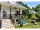 Charming front porch with classic railings, complemented by lush greenery and a well-maintained yard at 814 Carved Oak Ct, York, SC 29745