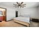 Cozy bedroom with a ceiling fan, neutral carpet, and a comfortable bed at 8152 Chilkoot Ln, Locust, NC 28097