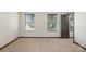 Empty bedroom with carpet, two windows that allow natural light and dark doors at 8152 Chilkoot Ln, Locust, NC 28097