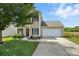 Charming two-story home with an attached garage, a well-maintained lawn, and a welcoming front entrance at 8152 Chilkoot Ln, Locust, NC 28097