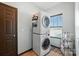 Bright laundry room with stackable washer and dryer and natural light from the window at 8152 Chilkoot Ln, Locust, NC 28097
