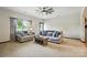 Comfortable living space with ample seating, natural light, and a ceiling fan for added comfort at 8152 Chilkoot Ln, Locust, NC 28097