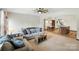 Spacious living area featuring open layout to kitchen and dining with neutral tones and comfortable seating at 8152 Chilkoot Ln, Locust, NC 28097