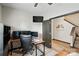 Home office area with modern desk, monitors, and open door to a staircase, for productivity at 8152 Chilkoot Ln, Locust, NC 28097
